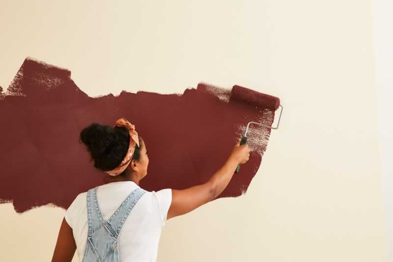 woman painting a wall